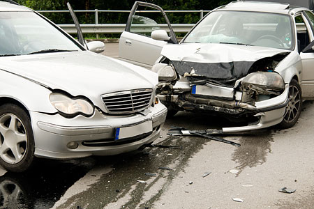 Zwei beschädigte Autos nach einem Unfall mit sichtbaren Schäden an der Karosserie.
