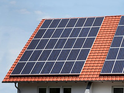 Ein Dach mit roten Ziegeln und Solarzellen.